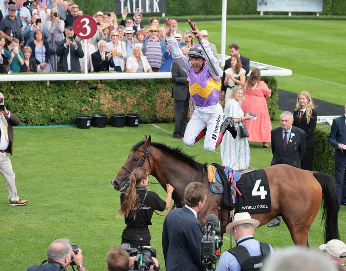 Frankie Dettori leaps off winner Kinross after winning the Lennox Stakes 